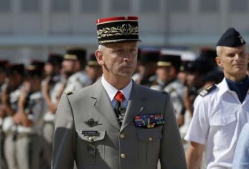 New armed forces chief of staff Gen. Francois Lecointre reviews the troops at the Istres air base, southern France, Thursday, July 20, 2017. (AP Photo/Claude Paris)