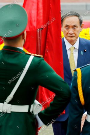 Mandatory Credit: Photo by Minh Hoang/AP/Shutterstock (10964461a) Japanese Prime Minister Yoshihide Suga, right, with his Vietnamese counterpart Nguyen Xuan Phuc, reviews an honor guard at the Presidential Palace in Hanoi, Vietnam, . Suga is on an official visit to Vietnam from Oct. 18 to 20, 2020 Japan, Hanoi, Vietnam - 19 Oct 2020