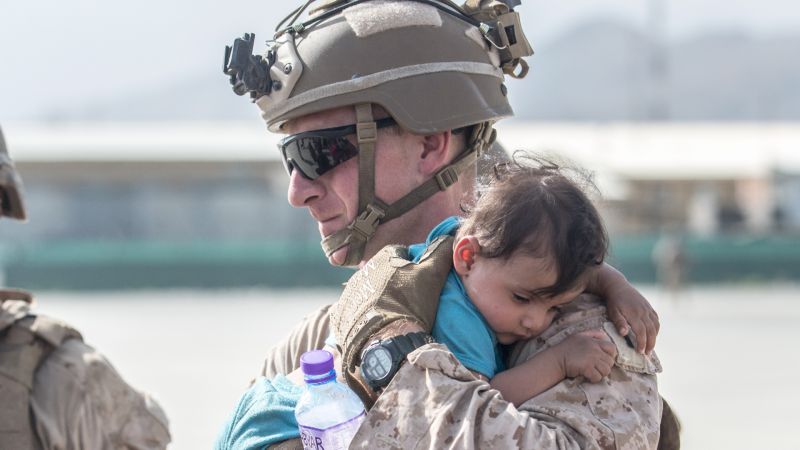 US Marine calms an infant during an evacuation at Hamid Karzai International Airport, Kabul, Afghanistan v2 210821 CREDIT US DEPARTMENT OF DEFENSE