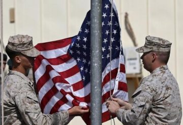 U.S. Marines lower their flag during a handover ceremony, as the last U.S. Marines unit and British combat troops end their Afghan operations, in Helmand October 26, 2014. REUTERS/Omar Sobhani