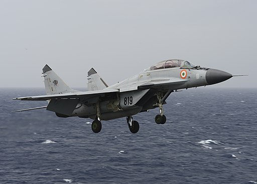 An Indian Navy MIG-29K Fulcrum flies over the aircraft carrier USS Nimitz (CVN 68) during Exercise Malabar 2017